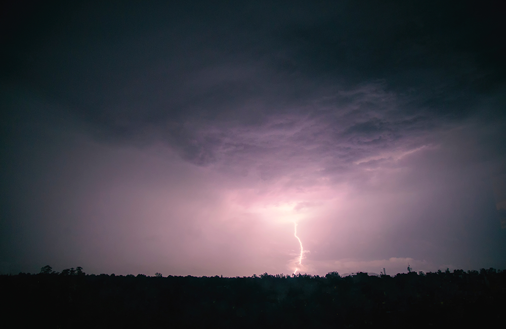 Lightning striking in a field