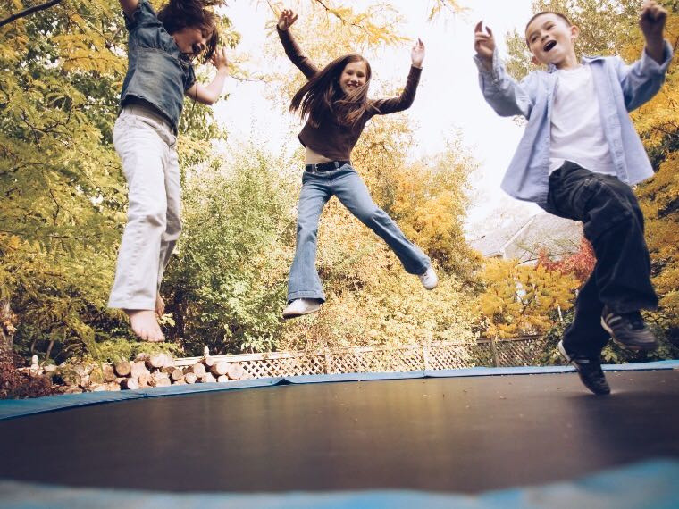 Children jumping on trampoline