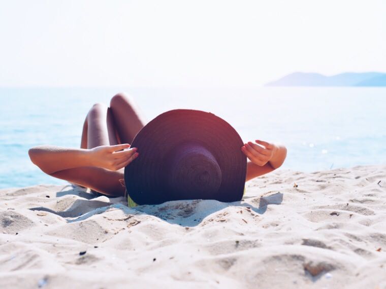 Woman at beach sun bathing