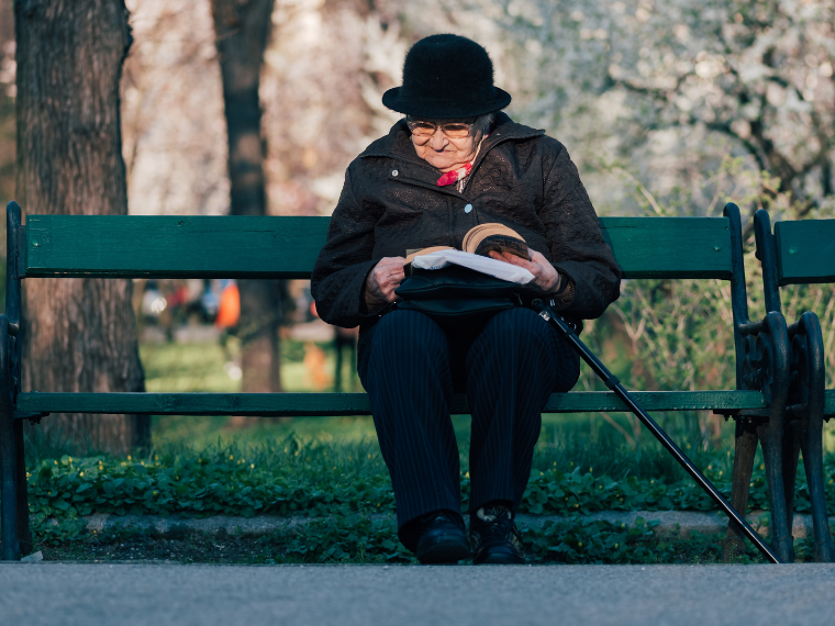 Woman reading on park bench